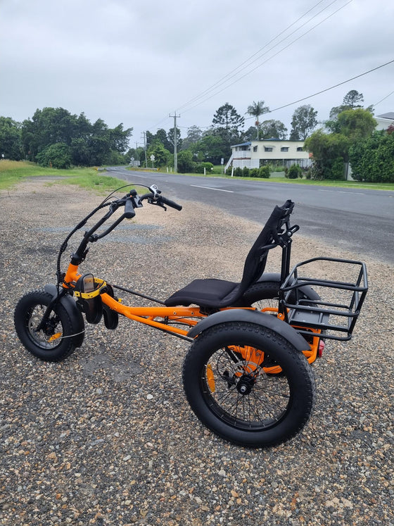 Side profile of orange coloured Trident FT fat-tyre semi-recumbent electric tricycle