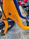 Close up view of orange lightning electric bike