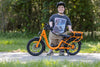 rider smiling with orange electric bike