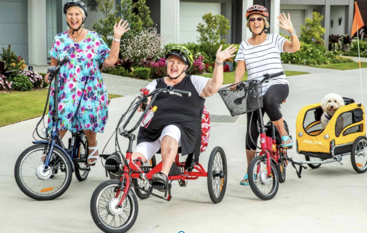  Women smilling while riding electric tricycles