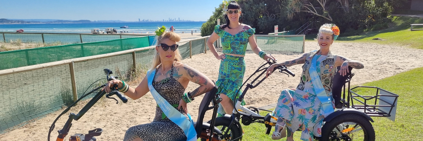 ladys sitting on electric trikes at the beach