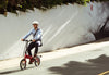 Man riding the red BF i-Ezi Folding Electric Bike in the street