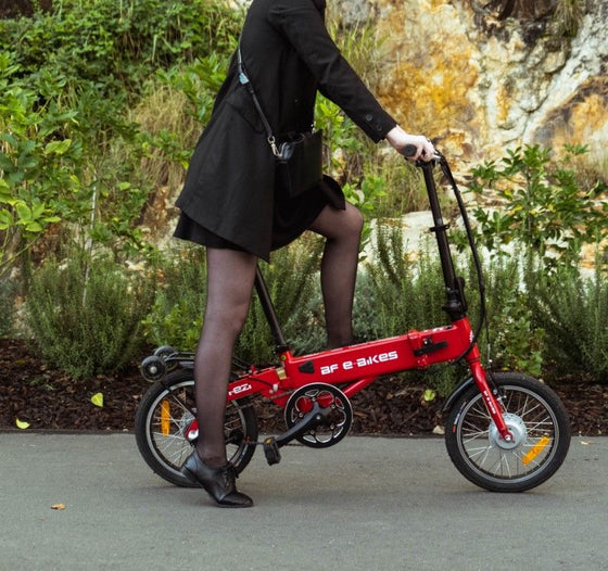 Lady riding the red BF i-Ezi Folding Electric Bike