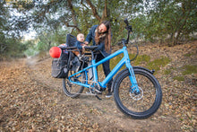  Father and baby riding Benno Boost electric long-tail cargo bike