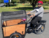 Man riding ORIGINAL BOX CARGO BIKE - ELECTRIC PLUS MODEL with daughter