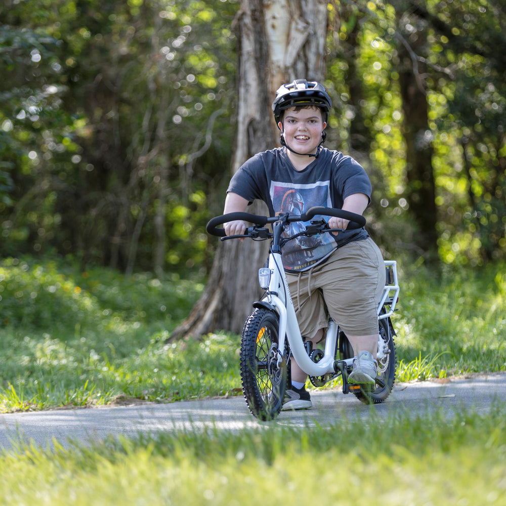 young man with acondroplasia riding a white lightning electric bike