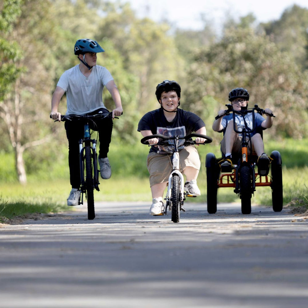 short stature riding electric bikes in the park