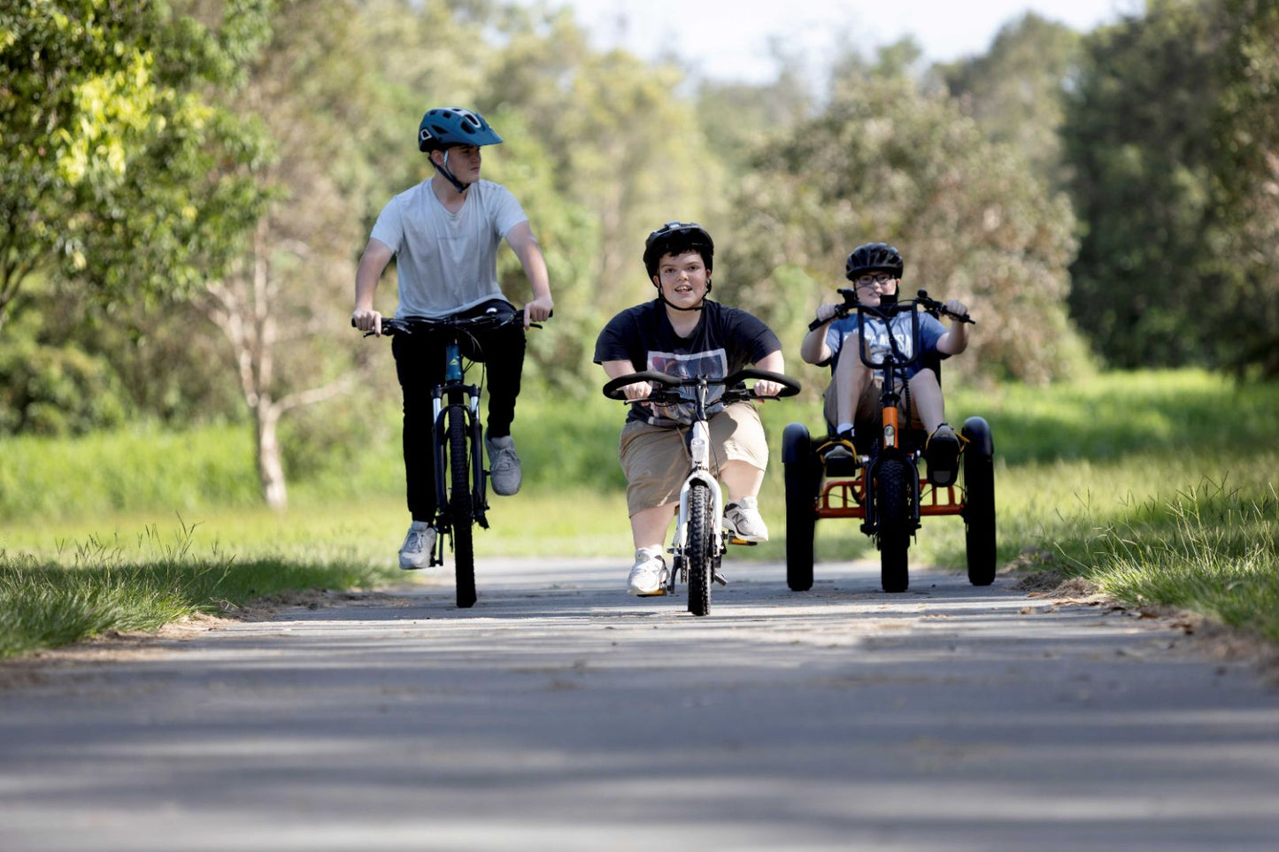 short stature riding electric bikes in the park