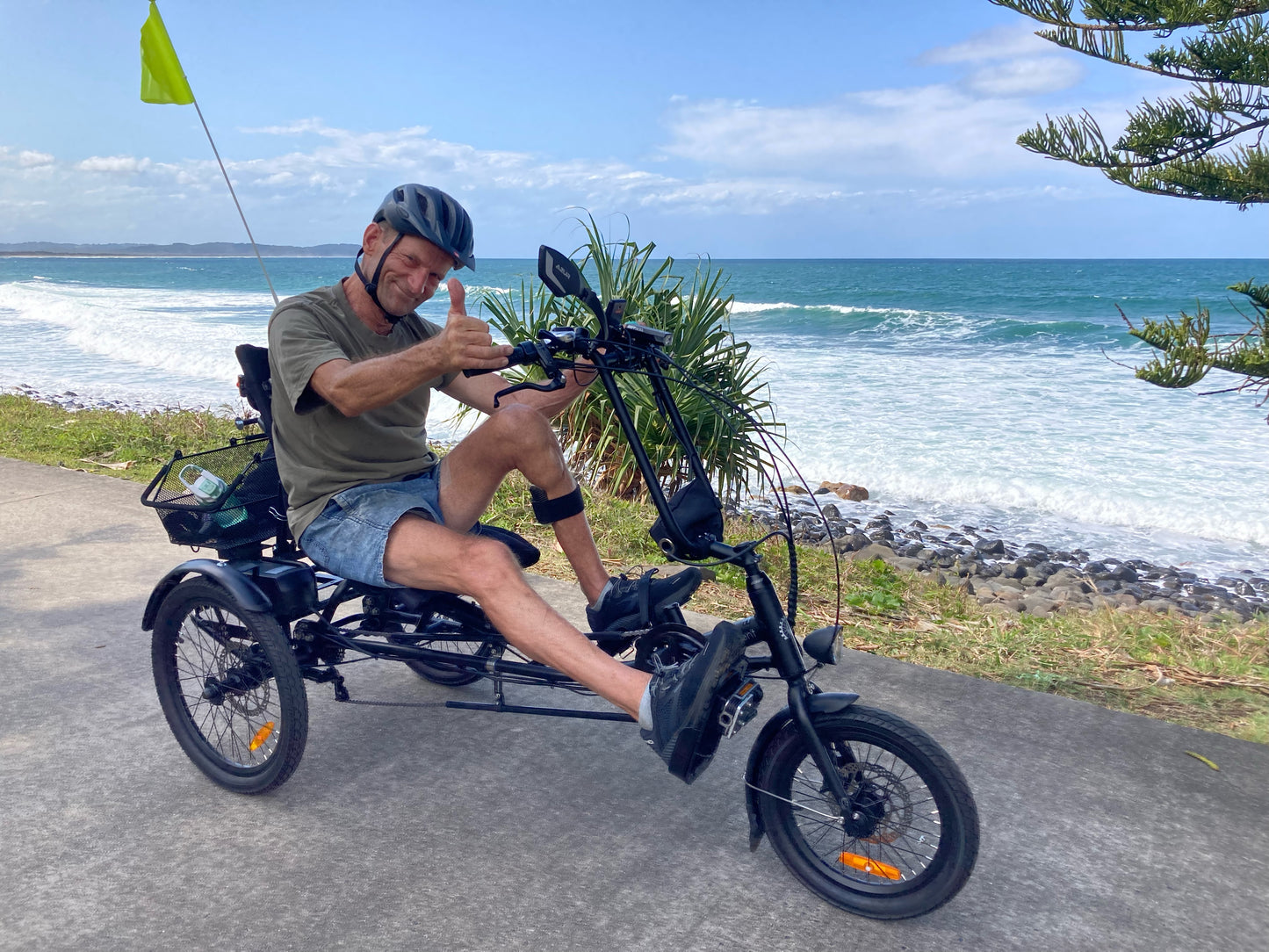 Roger riding a sit-down semi-recumbent tricycle after his stroke