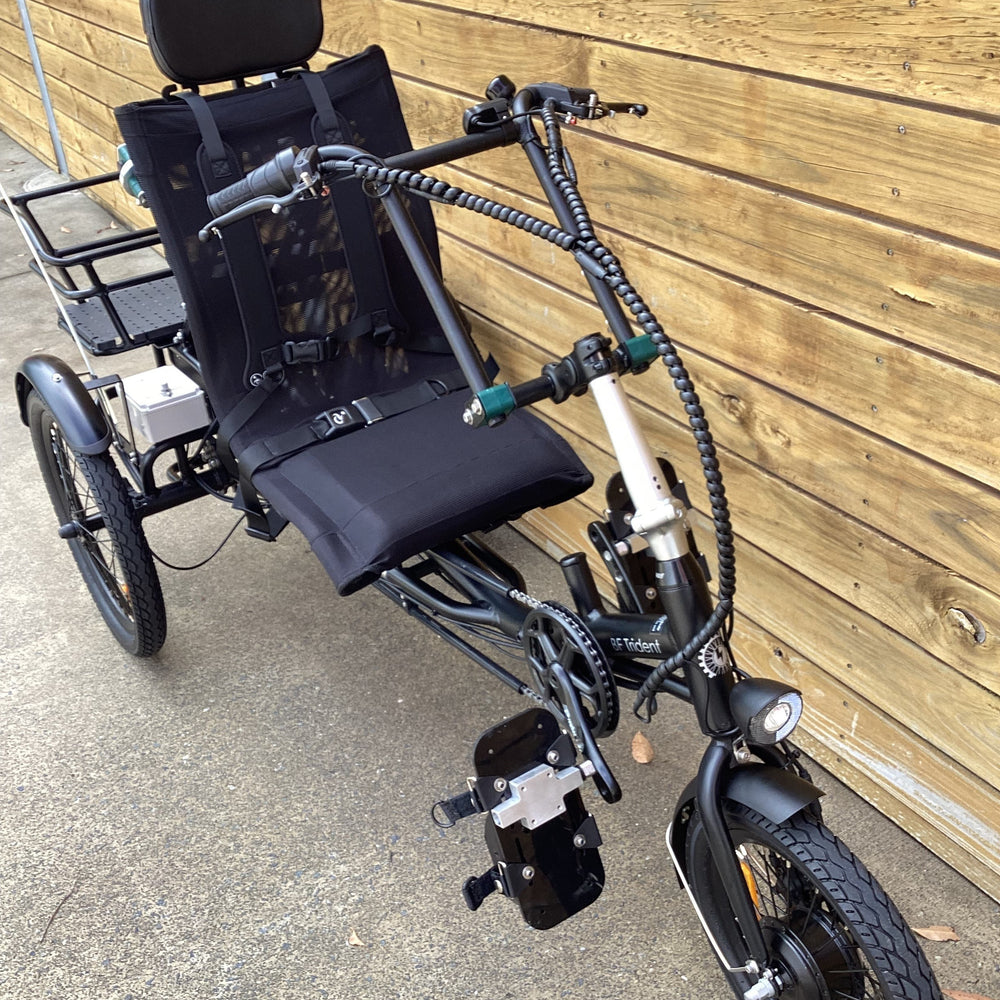 Modified semi-recumbent trike with adapted headrest, harness, handlebars and pedals