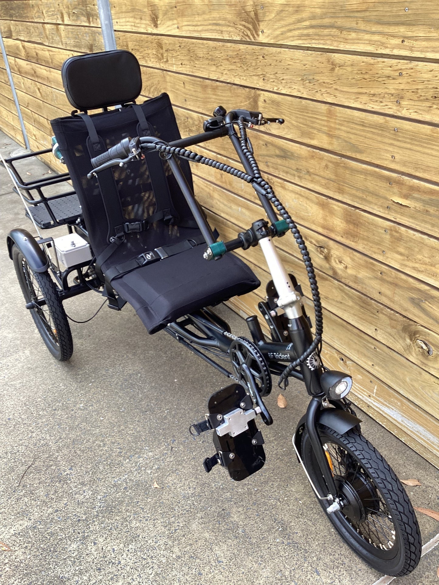 Modified semi-recumbent trike with adapted headrest, harness, handlebars and pedals