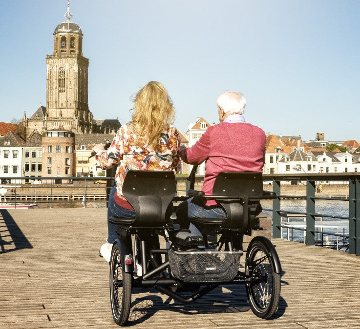 Elderly with support person riding an ebike