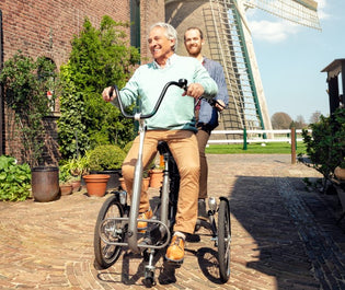  support person riding electric bike with elderly