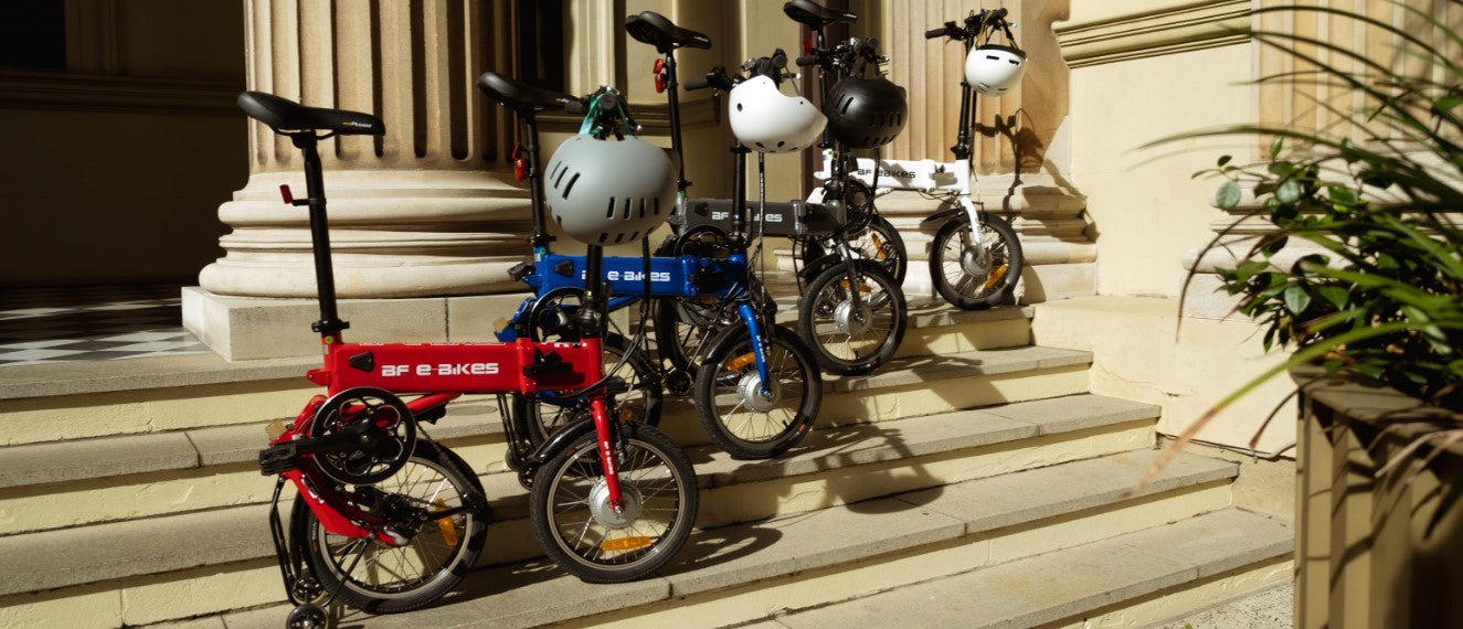 Folding electric bikes sitting on the steps of Customs House in Brisbane