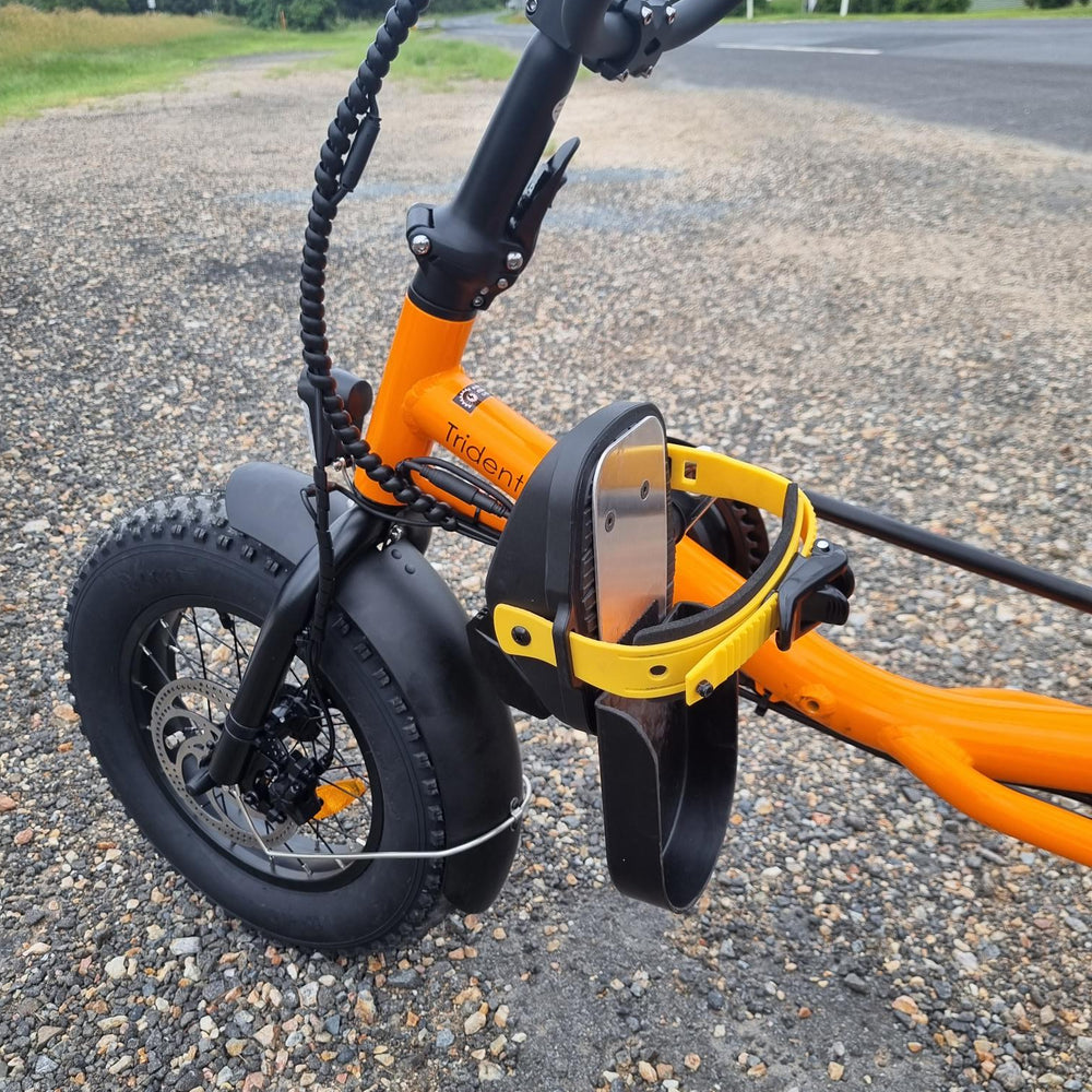 Close up view of pedals on orange coloured Trident FT fat-tyre semi-recumbent electric tricycle