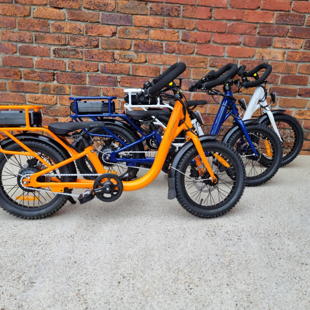 
                      
                        Line up of orange, navy and white electric bike
                      
                    