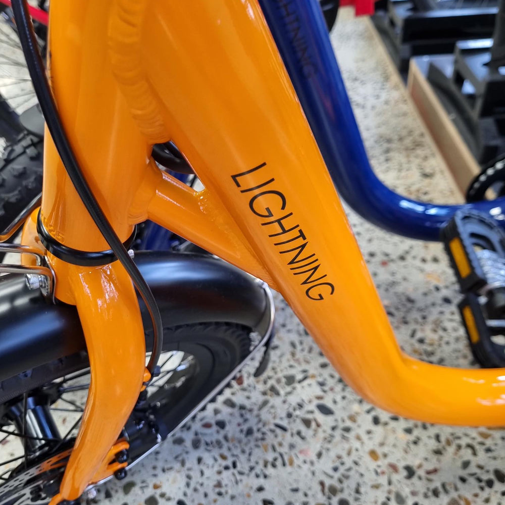 
                      
                        Close up view of orange lightning electric bike
                      
                    