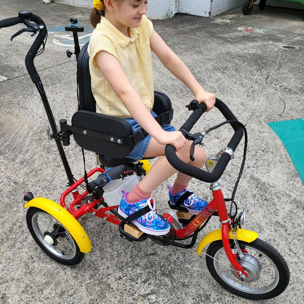 
                      
                        Young gilr riding the Muskateer 14" tricycle with rear steer and special needs mods
                      
                    