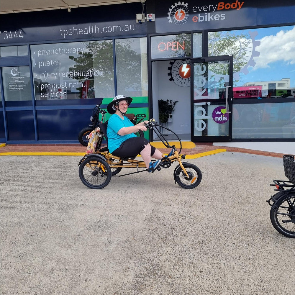 
                      
                        Happy customer riding the gold coloured Trident semi-recumbent electric tricycle
                      
                    