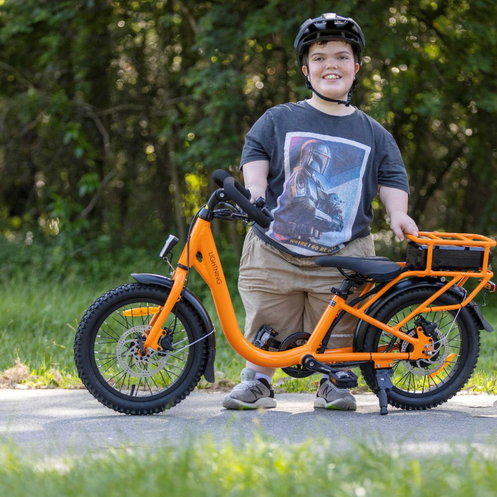 
                      
                        rider smiling with orange electric bike
                      
                    