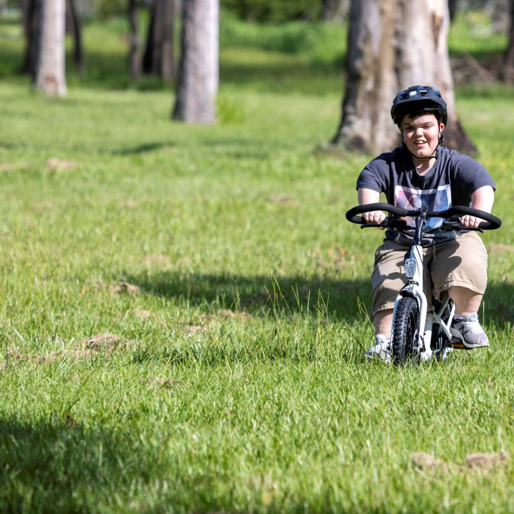 
                      
                        male smiling while riding electric bike
                      
                    