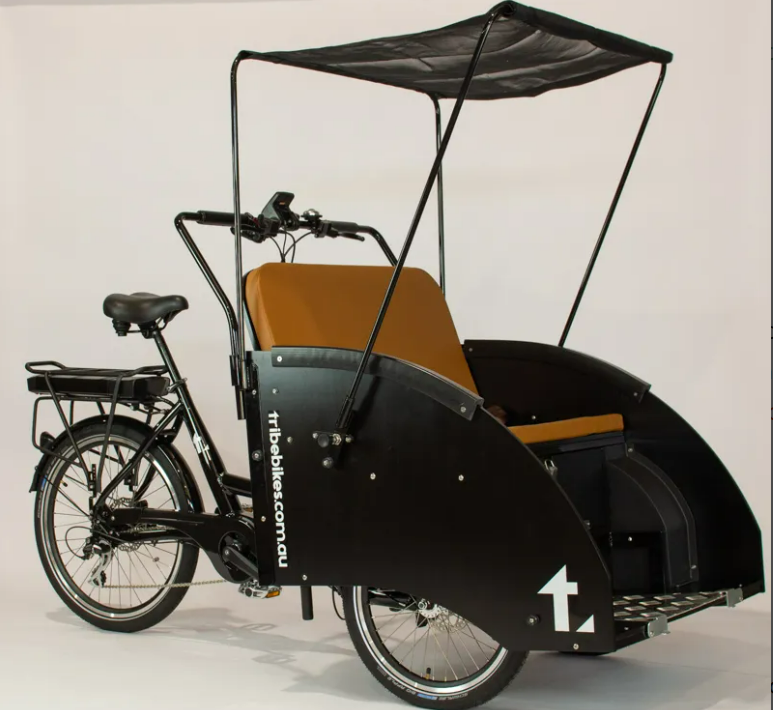 
                  
                    Black Tribe Bikes Ricky Rickshaw with yellow seat white the roof over the seat
                  
                