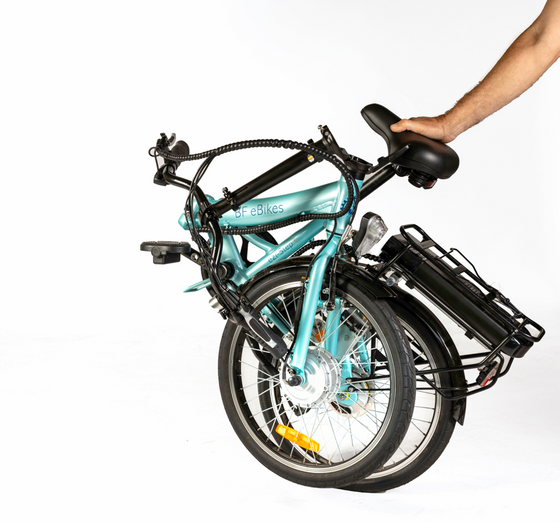 Aqua coloured Folding Electric Bike with adult stabilisers folded down to smaller size