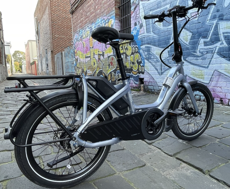 
                      
                        Silver Tern NBD S5i step-through ebike by street wall
                      
                    