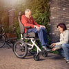 Support person putting elderly shoe on