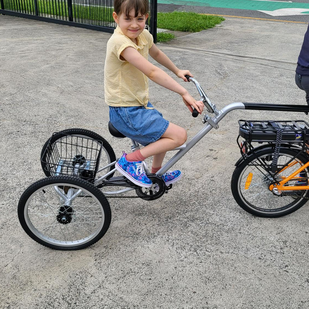 
                      
                        Young girl on the back of the Tandem Trailer Trike 
                      
                    