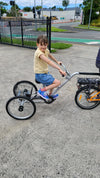 Young girl on the back of the Tandem Trailer Trike 