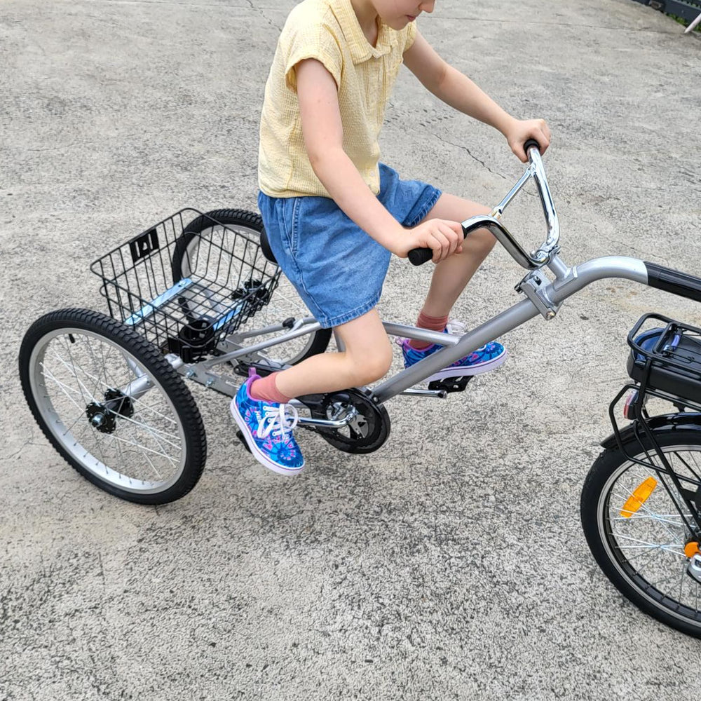 
                      
                        Young girl riding on the back of a Tandem Trailer Trike 
                      
                    