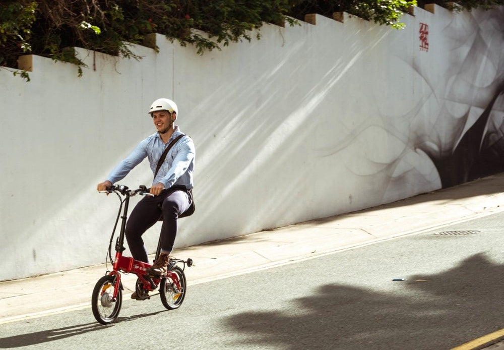 
                      
                        Man riding the red BF i-Ezi Folding Electric Bike in the street
                      
                    