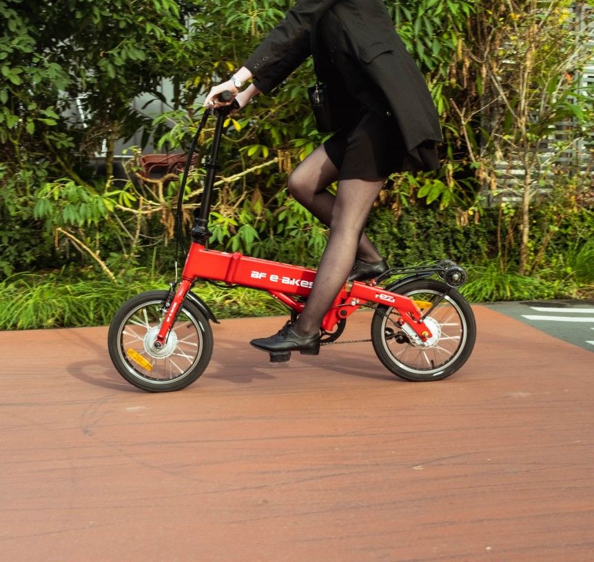 
                      
                        Lady riding the red BF i-Ezi Folding Electric Bike
                      
                    