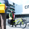 Mailman using Benno Boost electric long-tail cargo bike for deliveries