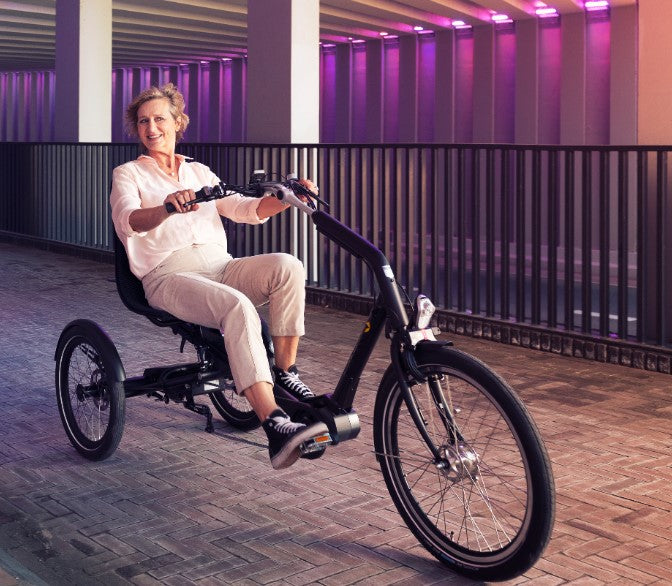 
                  
                    Older women riding the Huka Cortes Electric Tricycle
                  
                