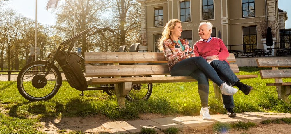 
                      
                        smiling people while sitting down after riding trike
                      
                    