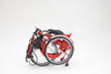 red folding tricycle folded to become smaller