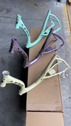 light yellow, green and purple bike parts side by side