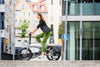 Women riding the Tern Vektron S10 Electric Folding ebike in the city