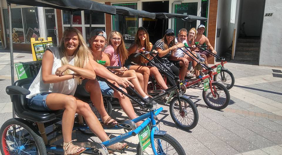 
                      
                        Group of people riding four different Worksman Team Dual electrical side-by-side tricycle
                      
                    